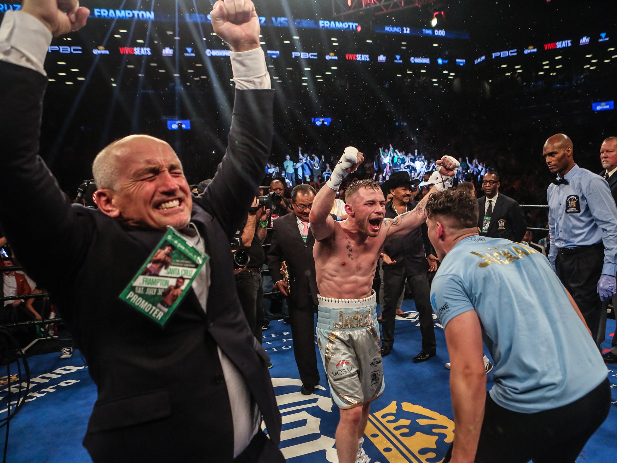 Carl Frampton celebrates with Shane and Barry McGuigan after beating Leo Santa Cruz in New York City last July