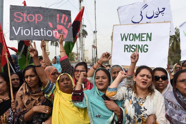 Activists of The Pakistan People's Party (PPP) hold placards as they march during a rally to mark International Women's Day in Karachi