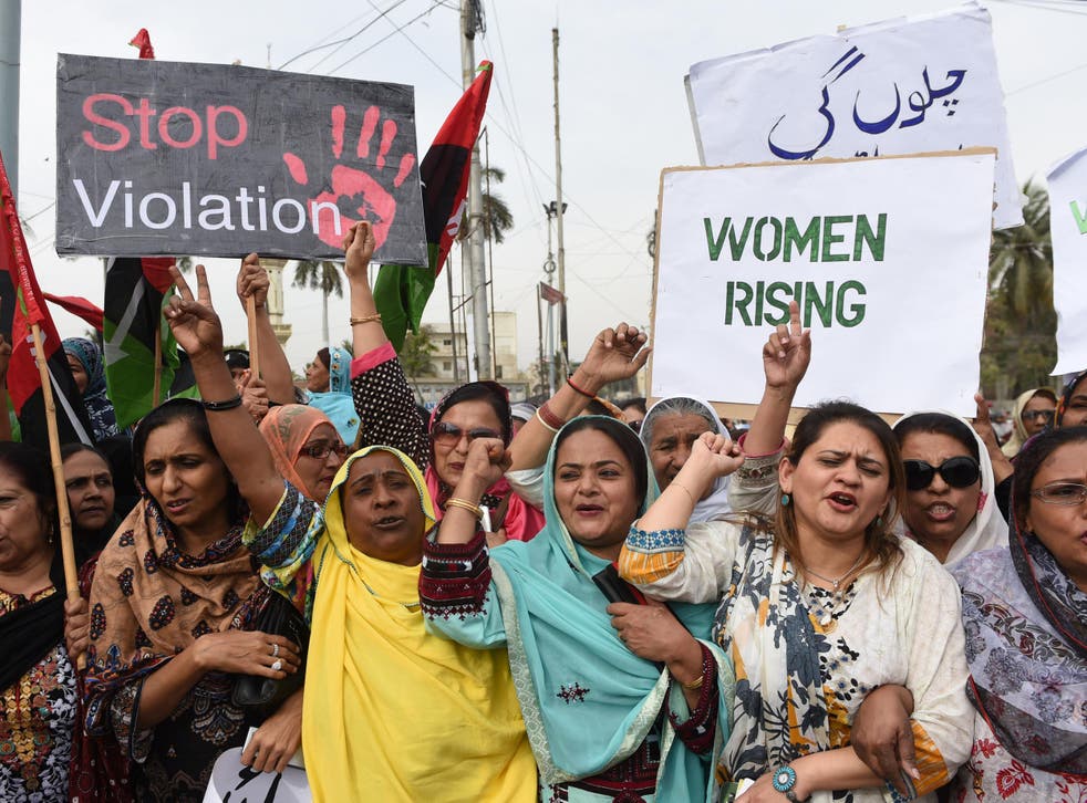 Activists of The Pakistan People's Party (PPP) hold placards as they march during a rally to mark International Women's Day in Karachi