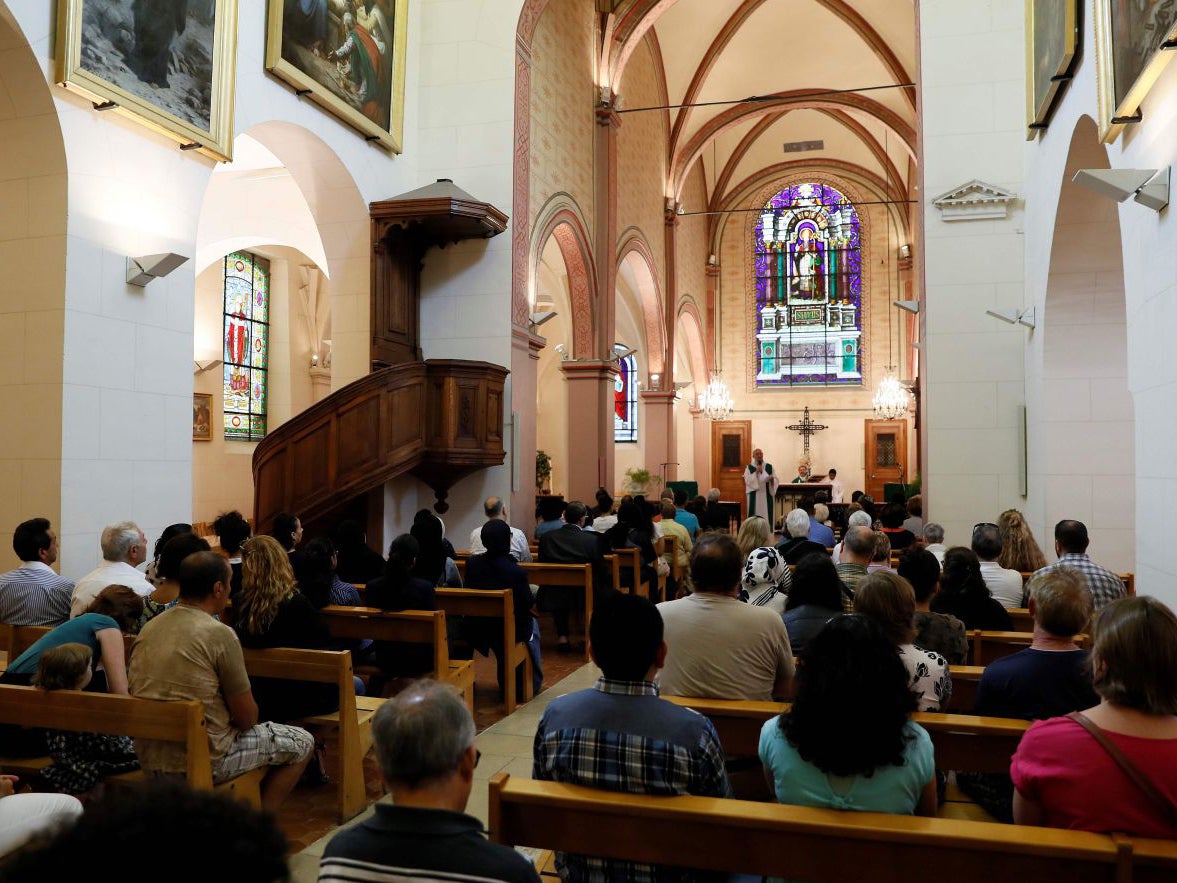 People attend a Mass in tribute to priest Jacques Hamel at the Bagnolet's Church, near Paris