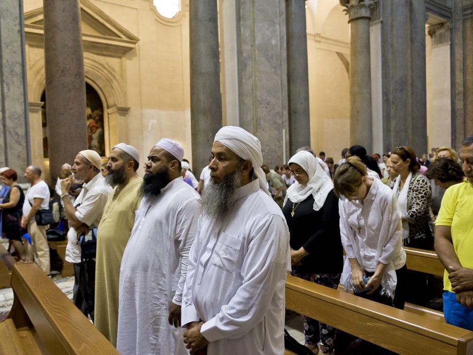 Muslims take part in a mass at the Basilica of the Holy Cross in Jerusalem on July 31, 2016 in Rome, Italy.