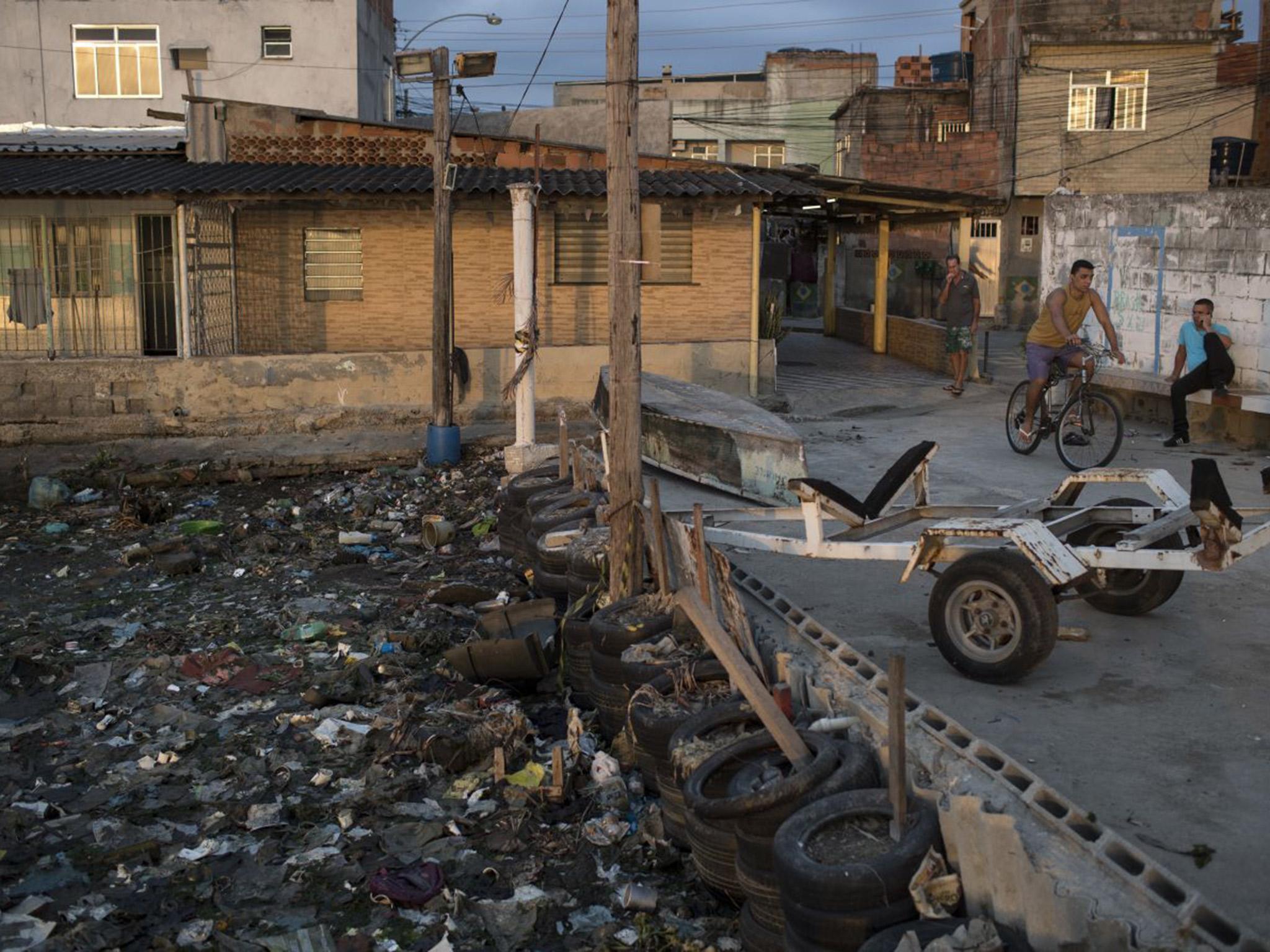 Houses stand next to the heavily polluted shore of Guanabara Bay