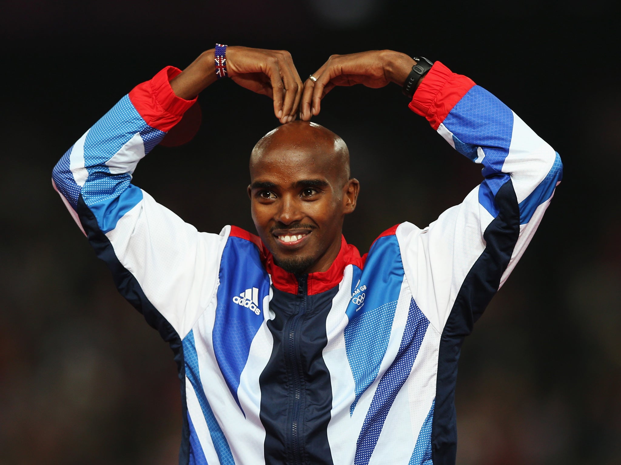 Farah celebrates on the podium after winning gold at London 2012