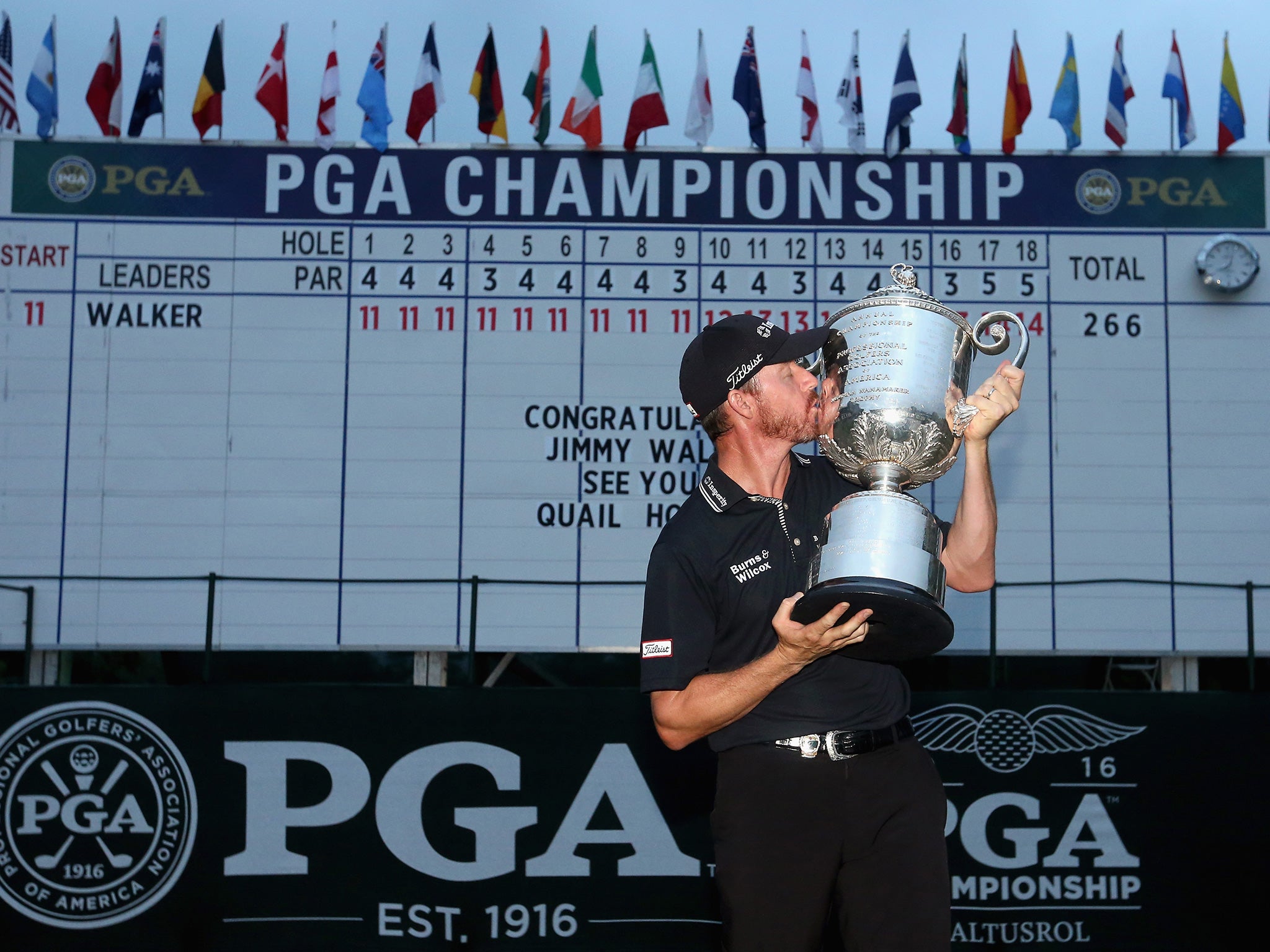Walker celebrates with the Wanamaker Trophy in front of the leaderboard