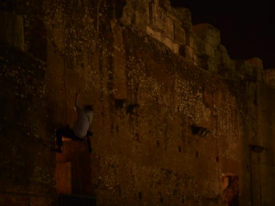 Two people are seen scaling down the iconic Flavian Amphitheatre in Rome, Italy