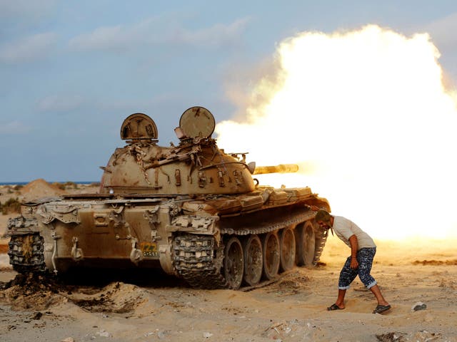 A fighter of Libyan forces allied with the UN-backed government fires a shell with Soviet made T-55 tank at Isis fighters in Sirte 