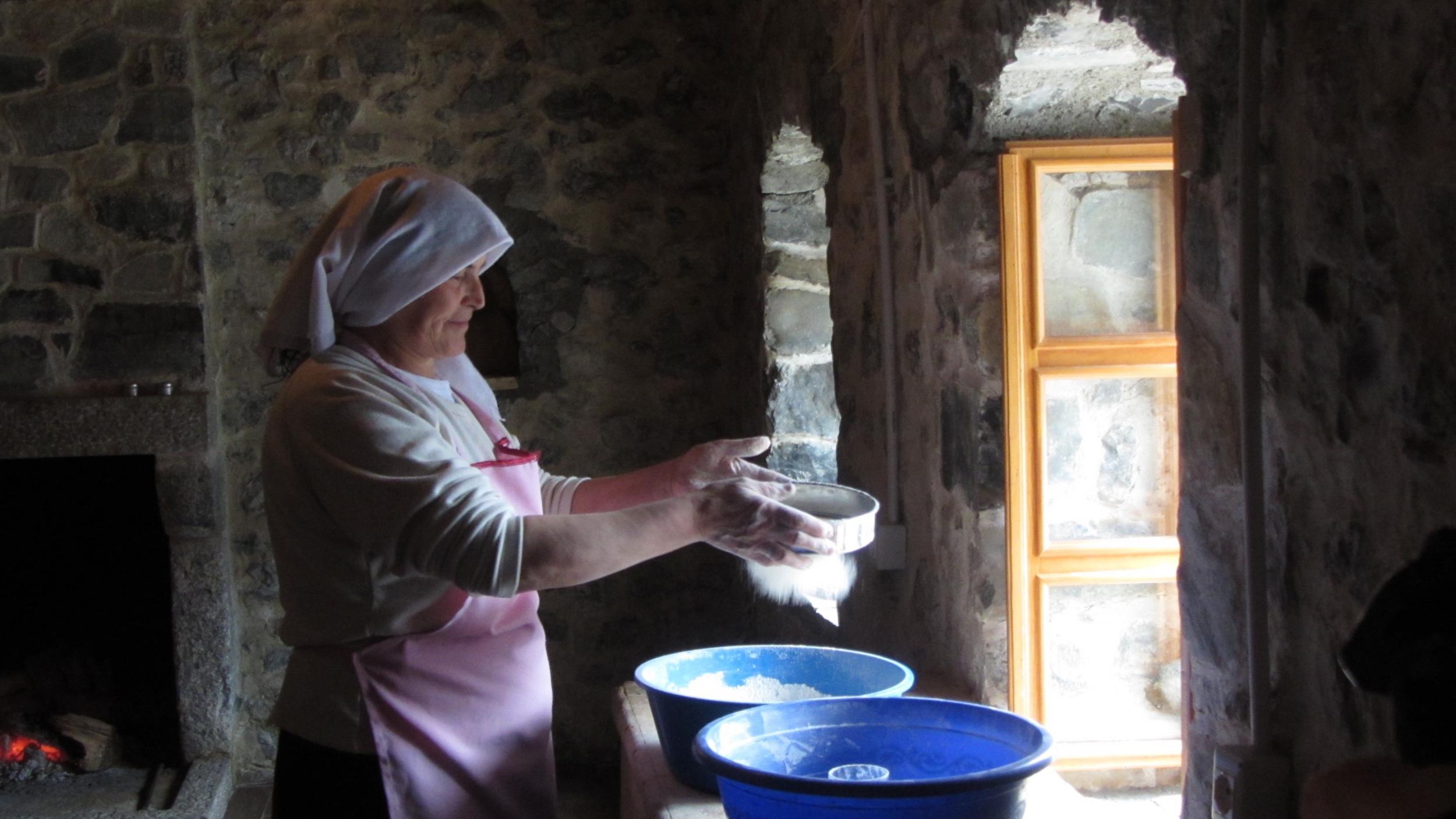 One of Theth's homestay hosts prepares 'fli', a staple dish made up of crepe-like layers (Elizabeth Gowing)