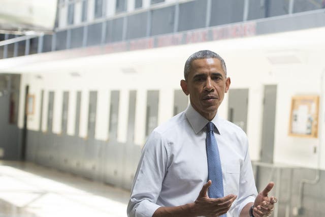 Obama speaks to reporters during a tour of an Oklahoma prison in July <em>Saul Loeb/Getty</em>