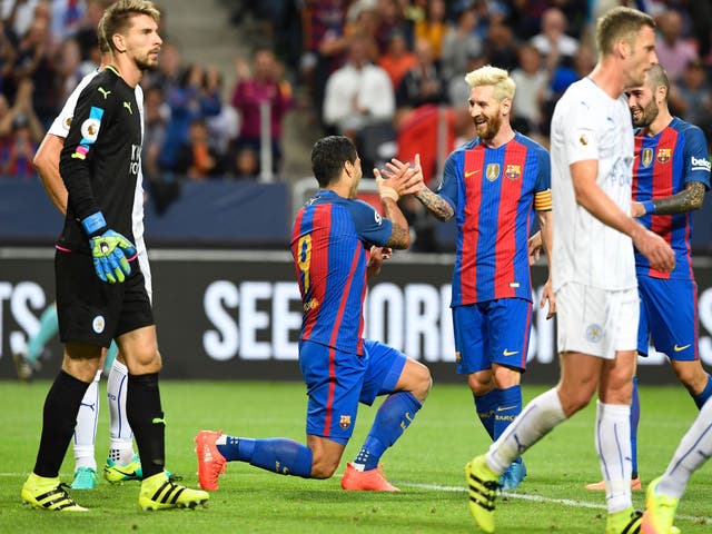 Lionel Messi congratulates Luis Suarez on his goal against Leicester City