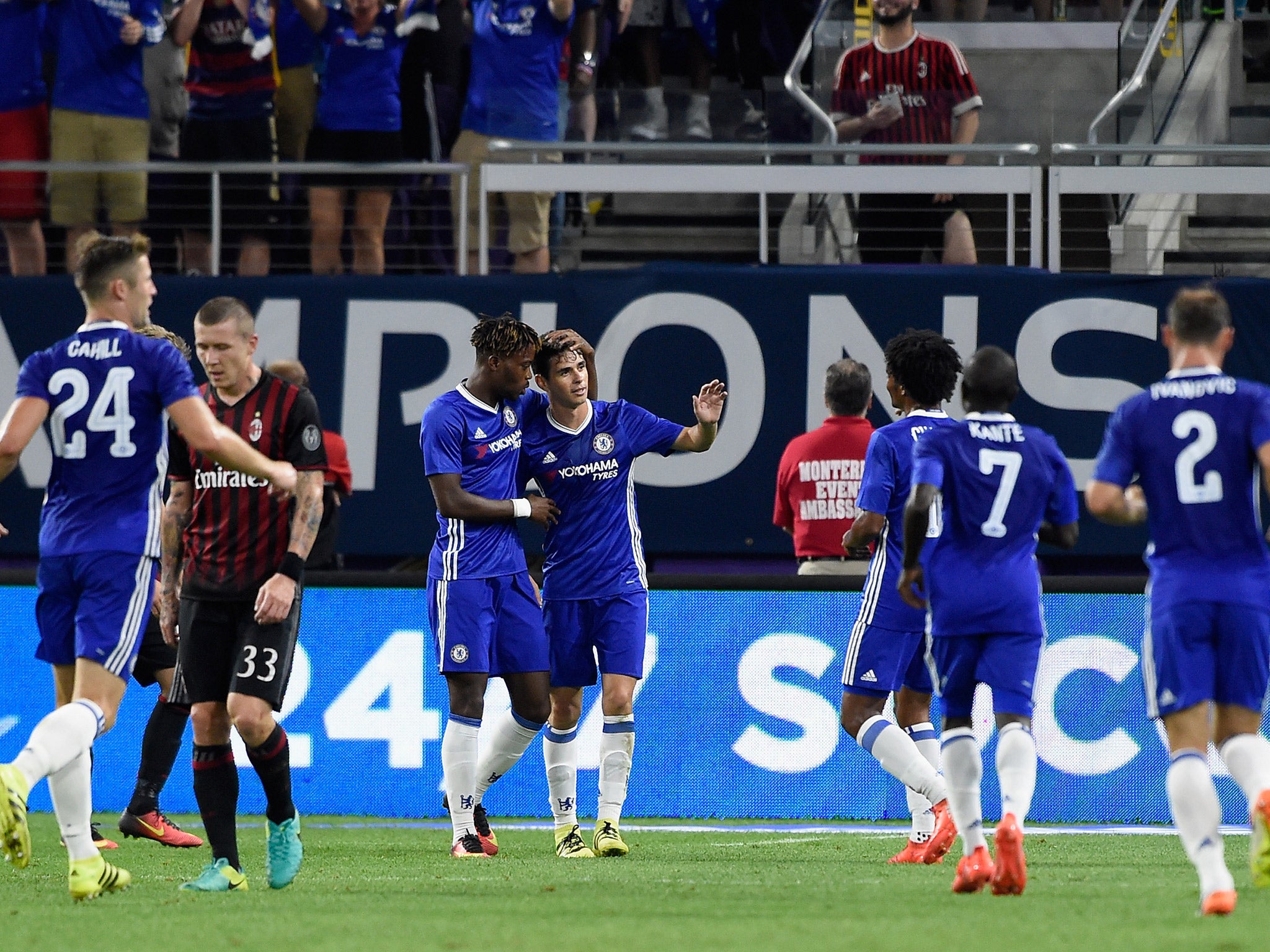 Oscar celebrates with his Chelsea teammates after scoring his second goal against AC Milan