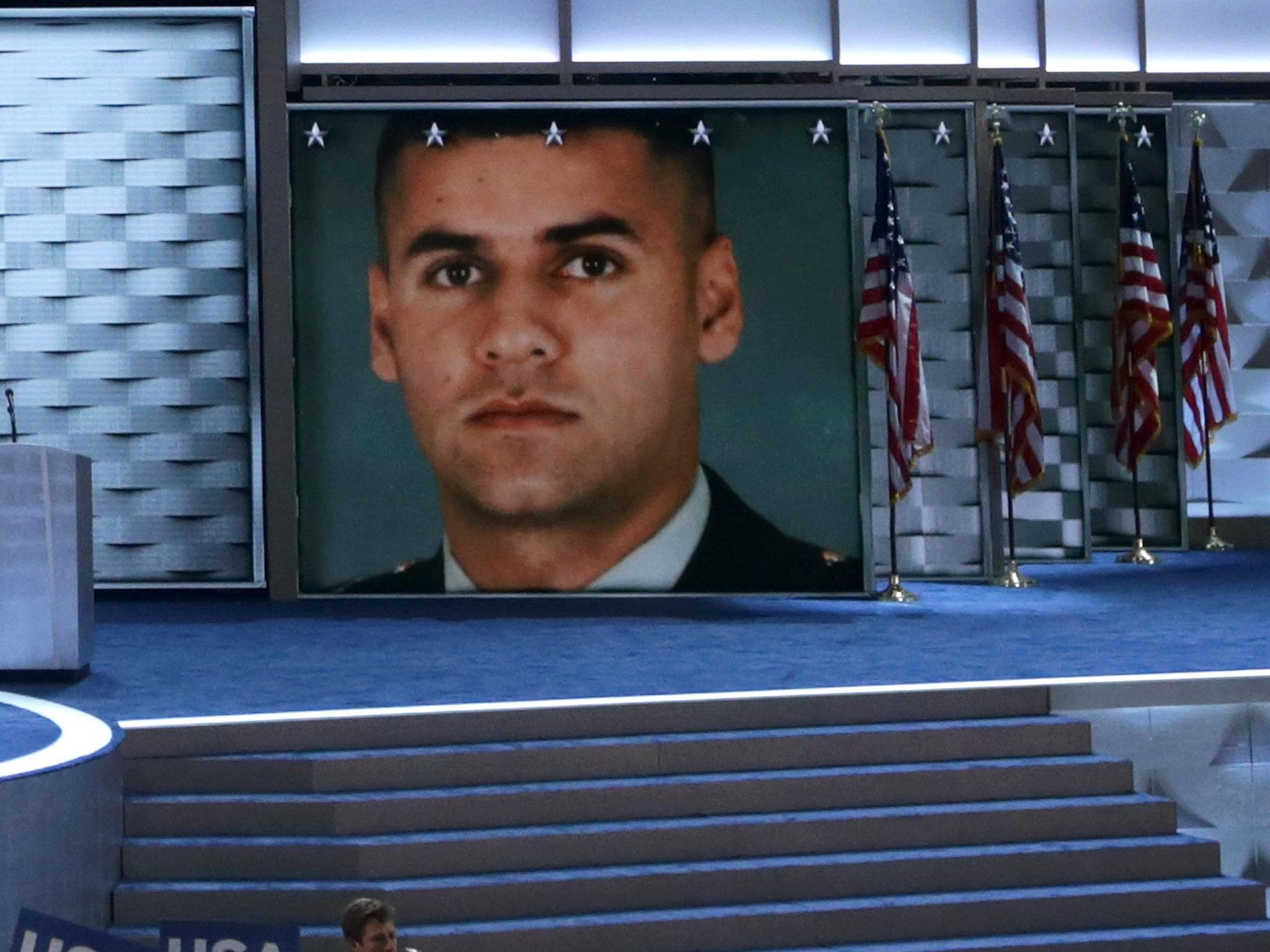 An image of fallen U.S. Army Capt. Humayun S. M. Khan is displayed on a screen as his father Khizr Khan delivers remarks on the fourth day of the Democratic National Convention