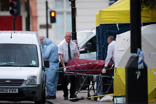 Police move the woman's body from the crime scene in Russell Square on Thursday