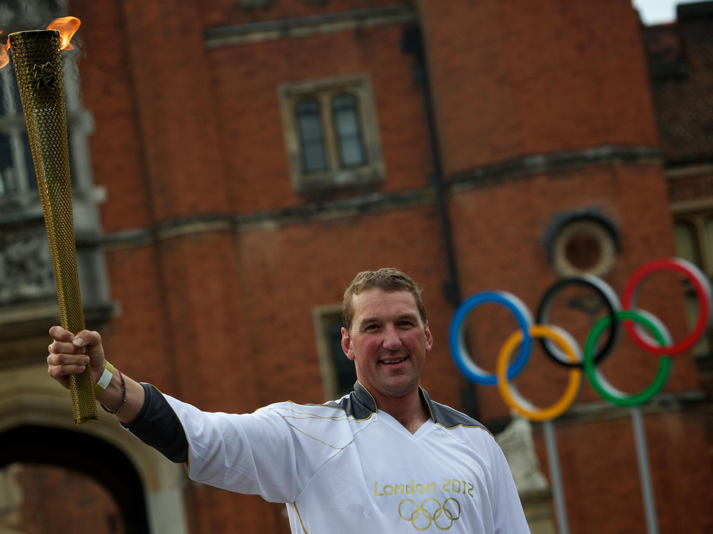 Matthew Pinsent at Hampton Court Palace with the Olympic torch in 2012
