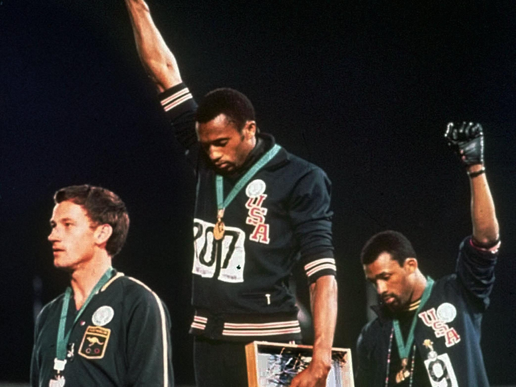 Tommie Smith and John Carlos raise a fist at the 1968 Olympics