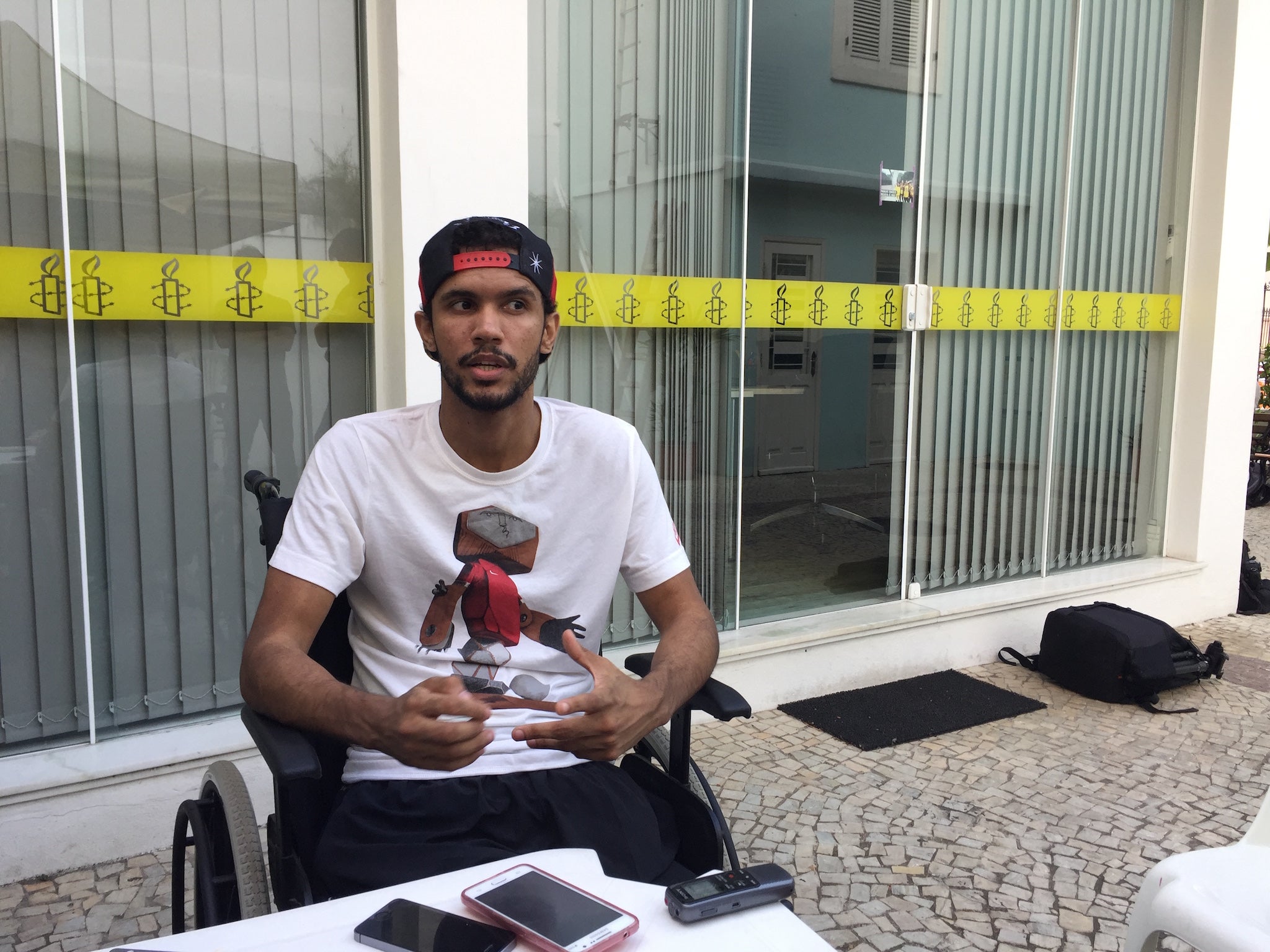 Vitor Santiago speaks to reporters in Rio on the eve of the Olympics (Amnesty International)