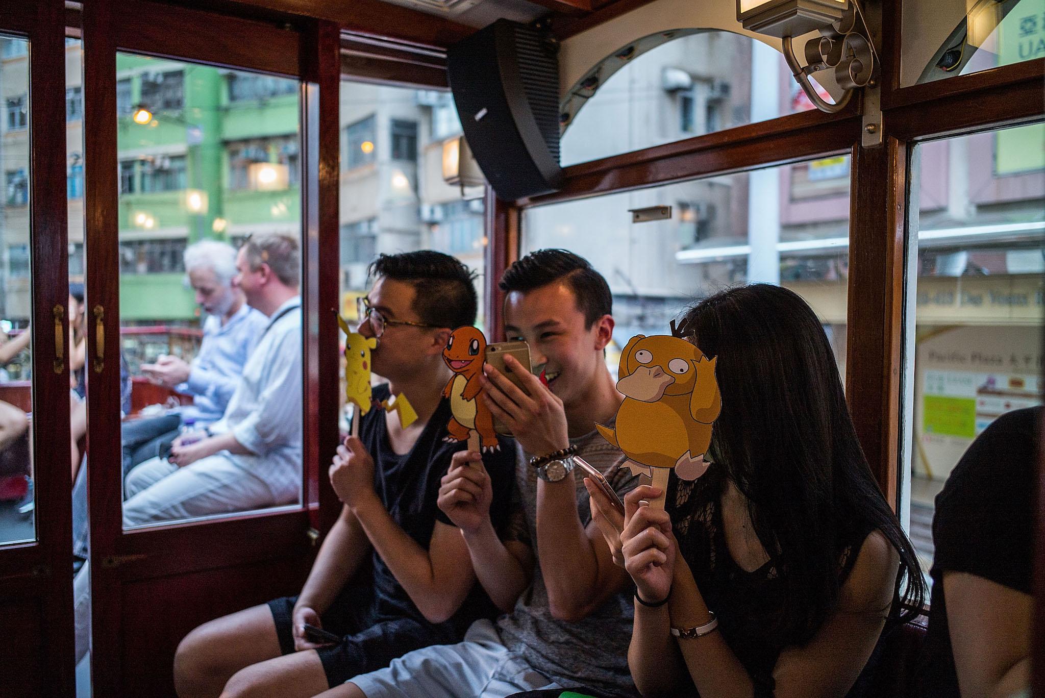 People join the Hong Kong's first Pokemon Go tram party organized by 'Sam the Local', on July 30, 2016 in Hong Kong