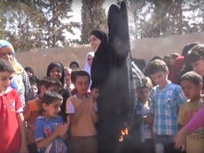 Syrian women burn burqas in celebration after being freed from Isis
