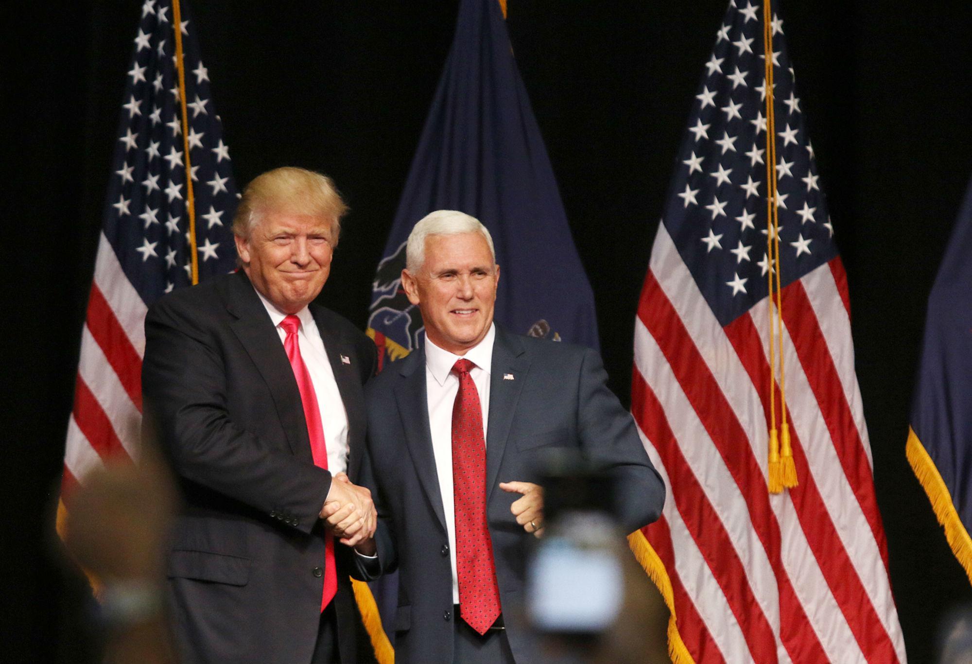 Mike Pence (right) insists he stands shoulder to shoulder with Donald Trump
