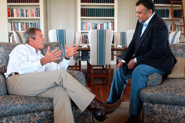 Prince Bandar bin Sultan, Saudi Ambassador to the US, speaking to former President George W Bush at the Bush Ranch in Crawford, Texas, in August 2002. An 'indirect link' between Prince Bandar and an al-Qaeda suspect is revealed in a 9/11 investigatory report