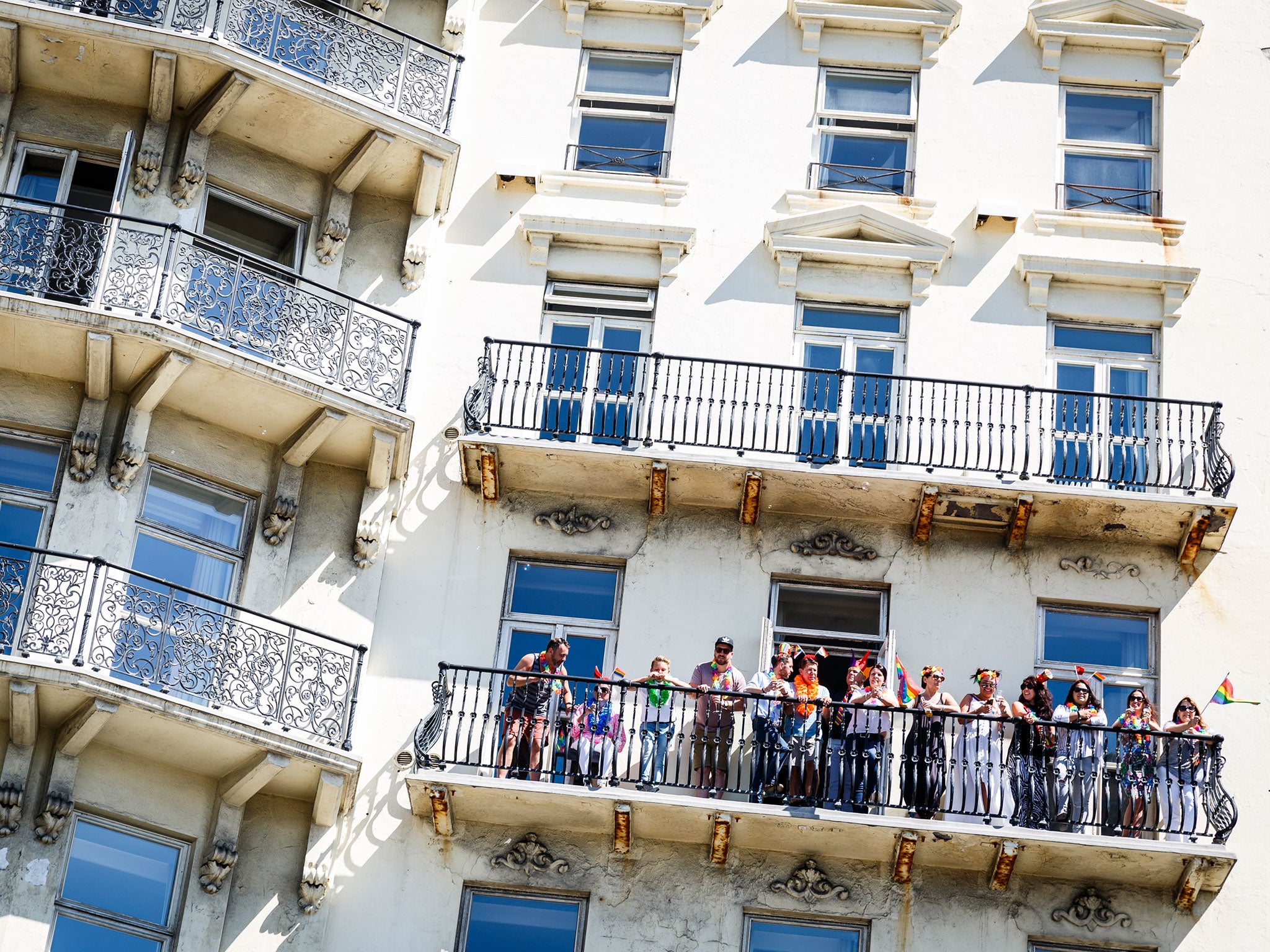 Some people took to beachfront balconies to get an aerial view of Brighton Pride as it unfolded below