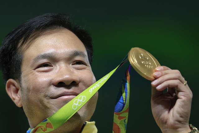 Hoang Xuan Vinh of Vietnem displays his gold medal following the victory ceremony for the men's 10-meter air pistol event at Olympic Shooting Center at the 2016 Summer Olympics in Rio de Janeiro, Brazil, Saturday, Aug. 6, 2016