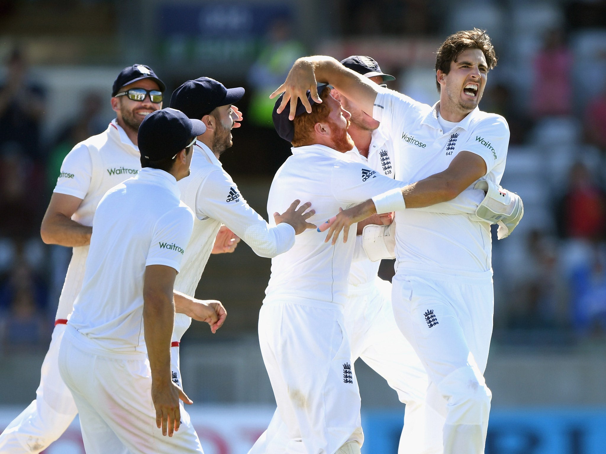 Steven Finn is swamped by his England teammates after taking the wicket of Sami Aslam