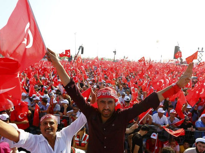 People wave Turkey's national flags during the Democracy and Martyrs Rally