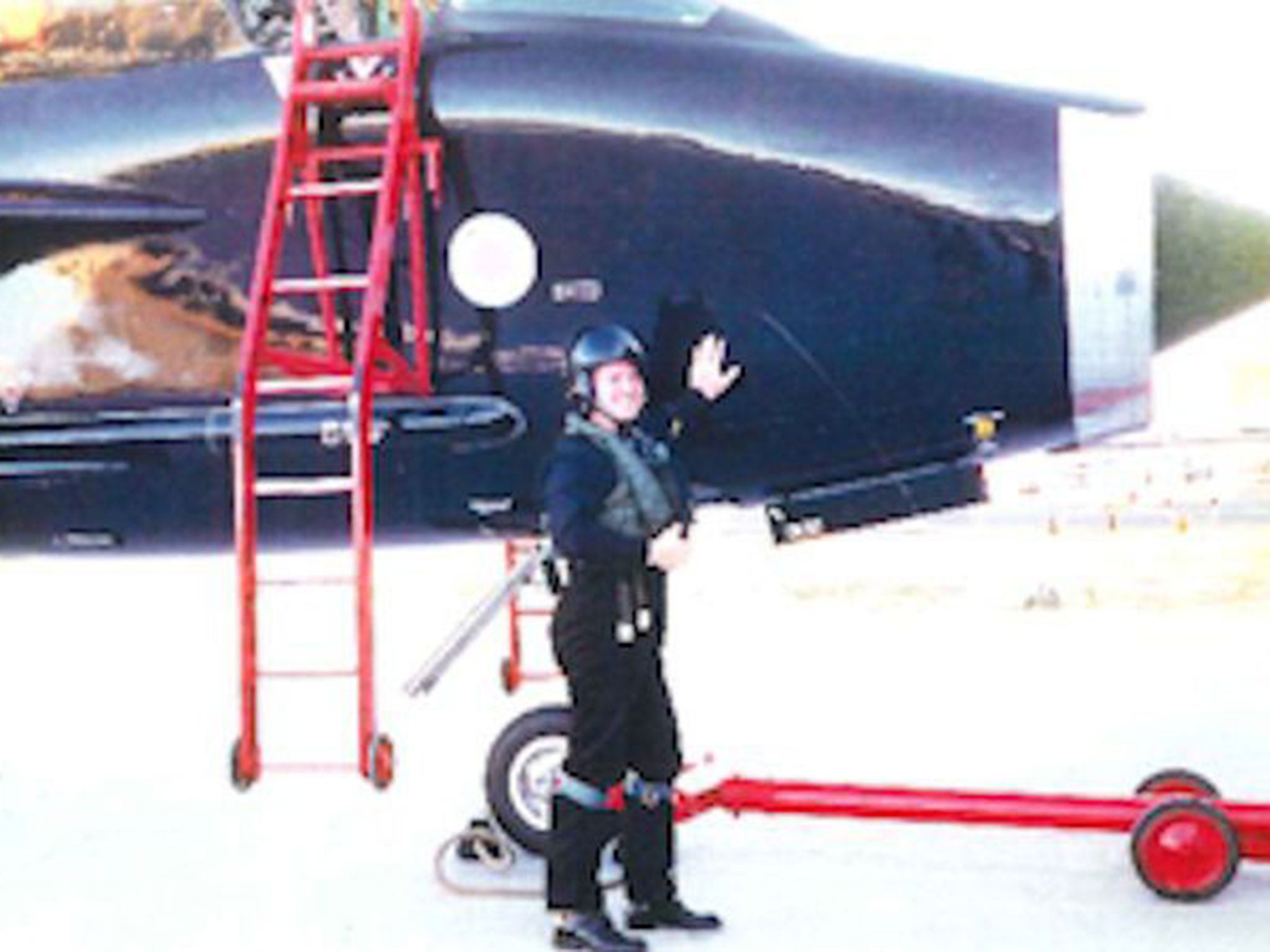 A photograph of Mr Wells standing by a Lightning aircraft