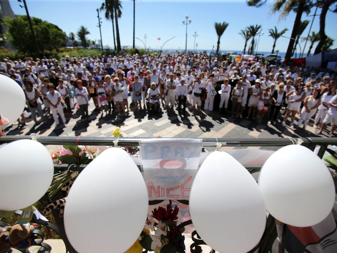 People dressed in white attend a minute of silence held for the victims of the Bastille Day attack in the city of Nice