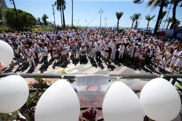 People dressed in white attend a minute of silence held for the victims of the Bastille Day attack in the city of Nice