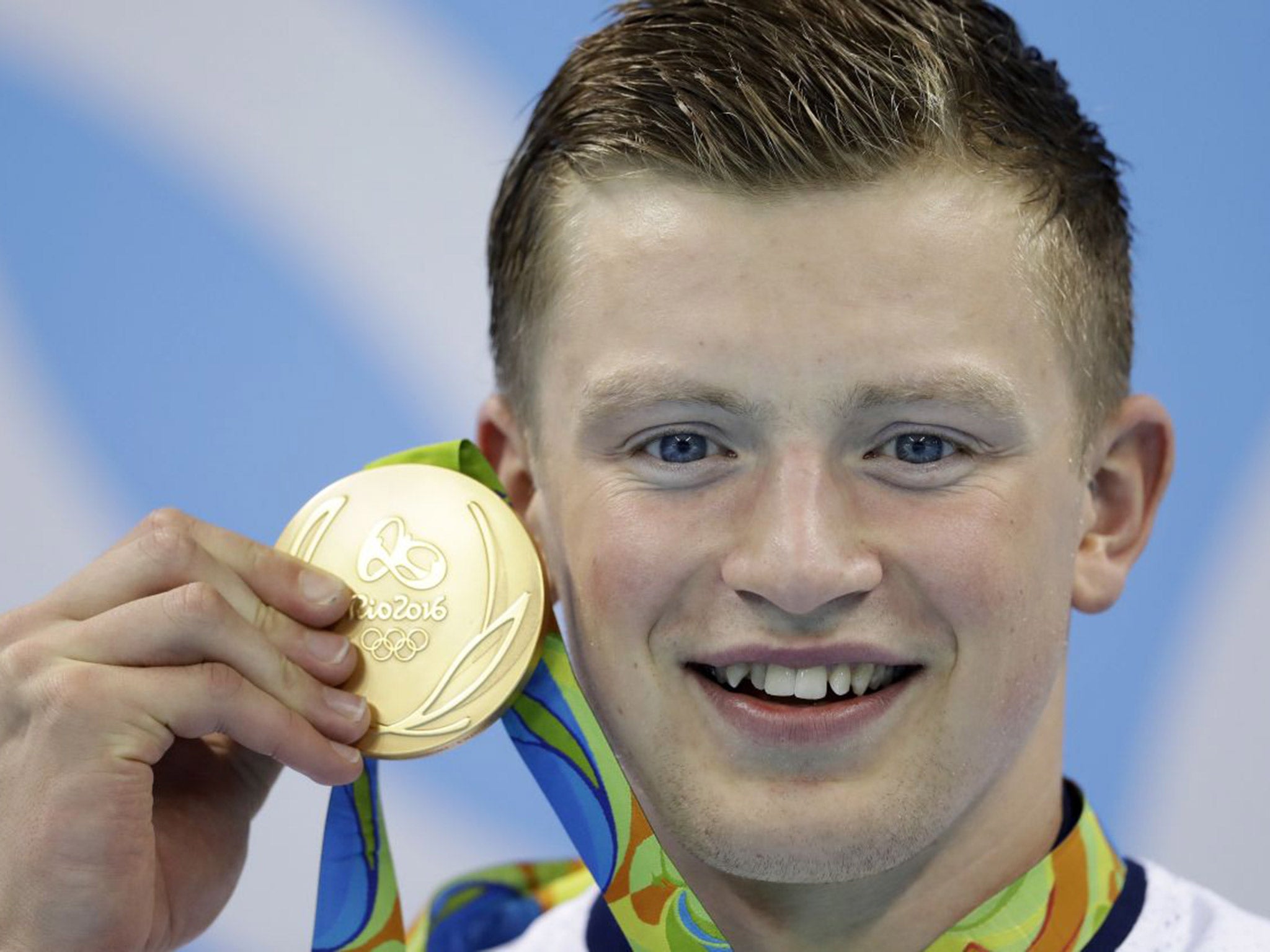 Adam Peaty poses with his 100m breaststroke gold medal