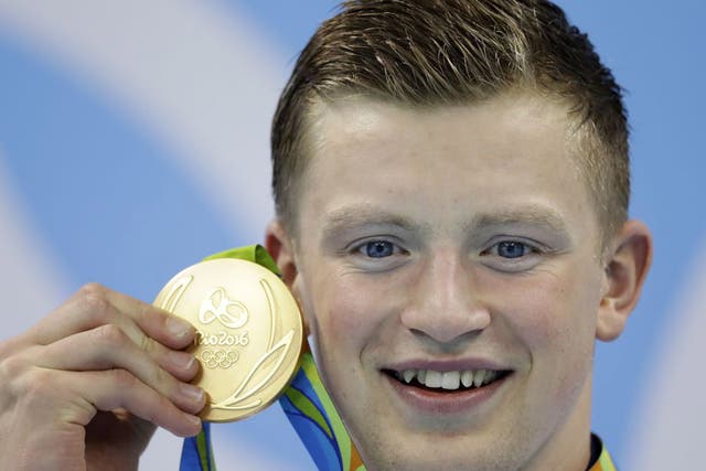 Adam Peaty poses with his 100m breaststroke gold medal