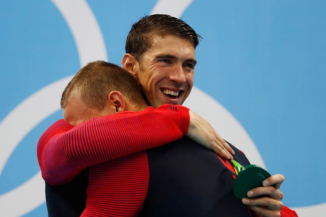 Phelps celebrates his gold medal with team-mate Caeleb Dressell