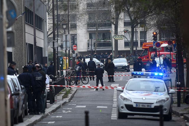Ambulances and police officers gather in front of the offices of the French satirical magazine Charlie Hebdo on January 7, 2015, in Paris, France