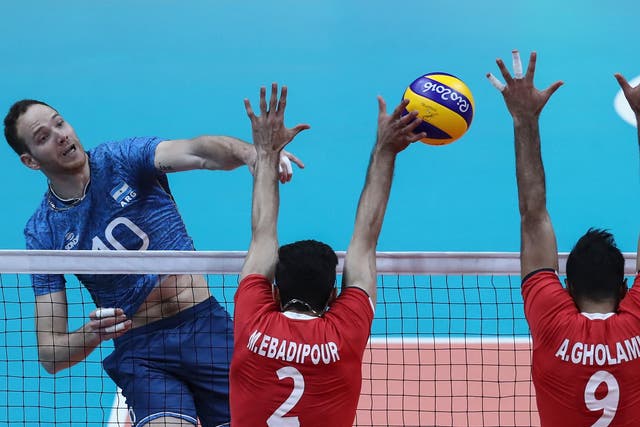 Jose Luis Gonzalez of Argentina jumps to spike the ball against Iran during the Men's Preliminary Pool A match