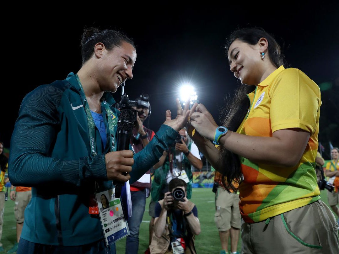 Volunteer Marjorie Enya (R) proposes marriage to rugby player Isadora Cerullo (Getty Images )