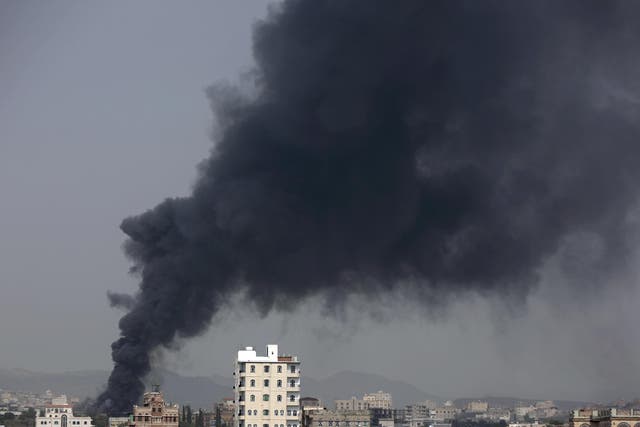 Smoke rises from a food factory in Sanaa where 14 workers were killed
