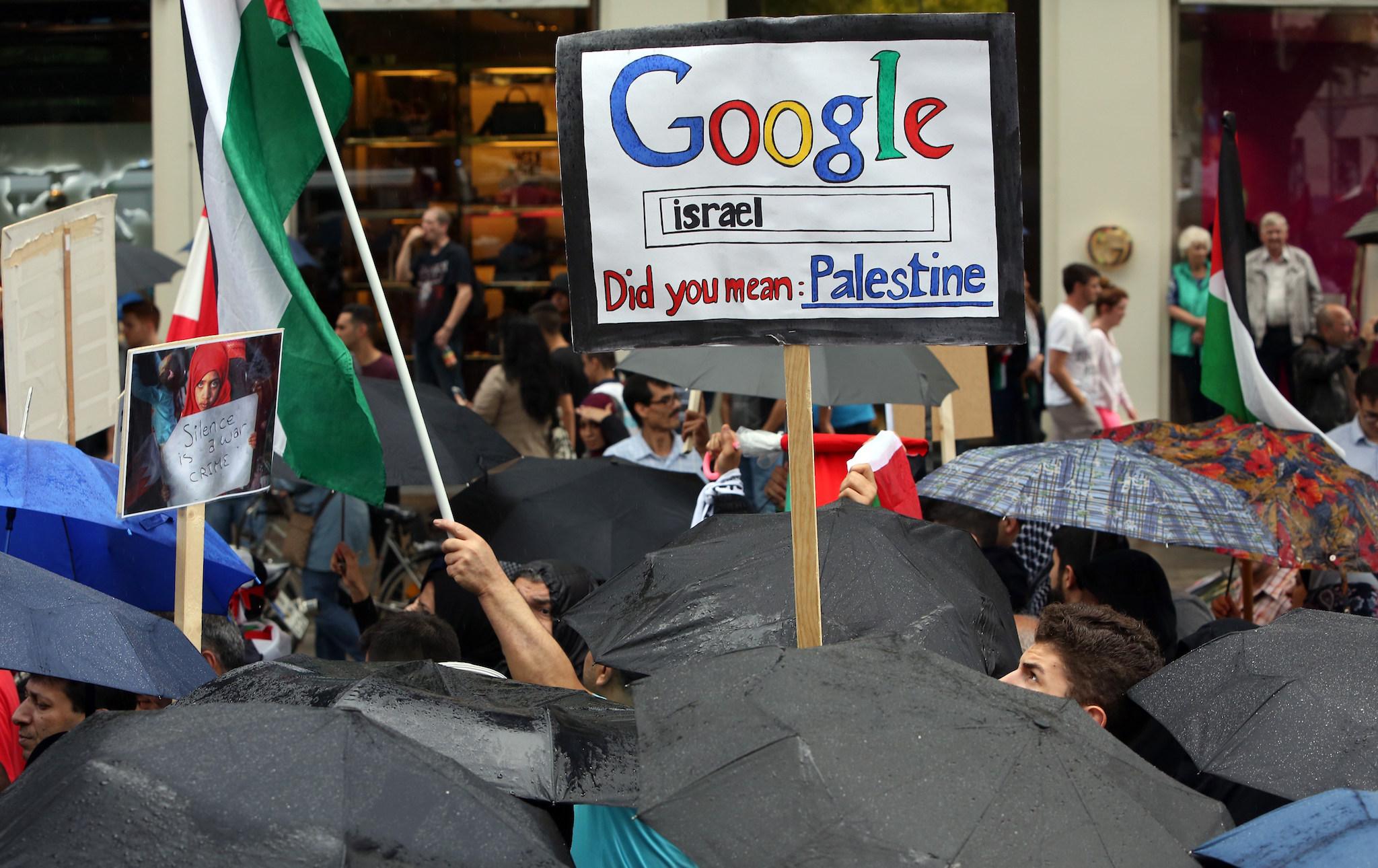Demonstrators hold a placard reading 'Google Israel - did you mean Palestine' during a rally for Al-Quds Day, an event intended to express solidarity with the Palestinian people, on July 25, 2014 in Berlin, Germany