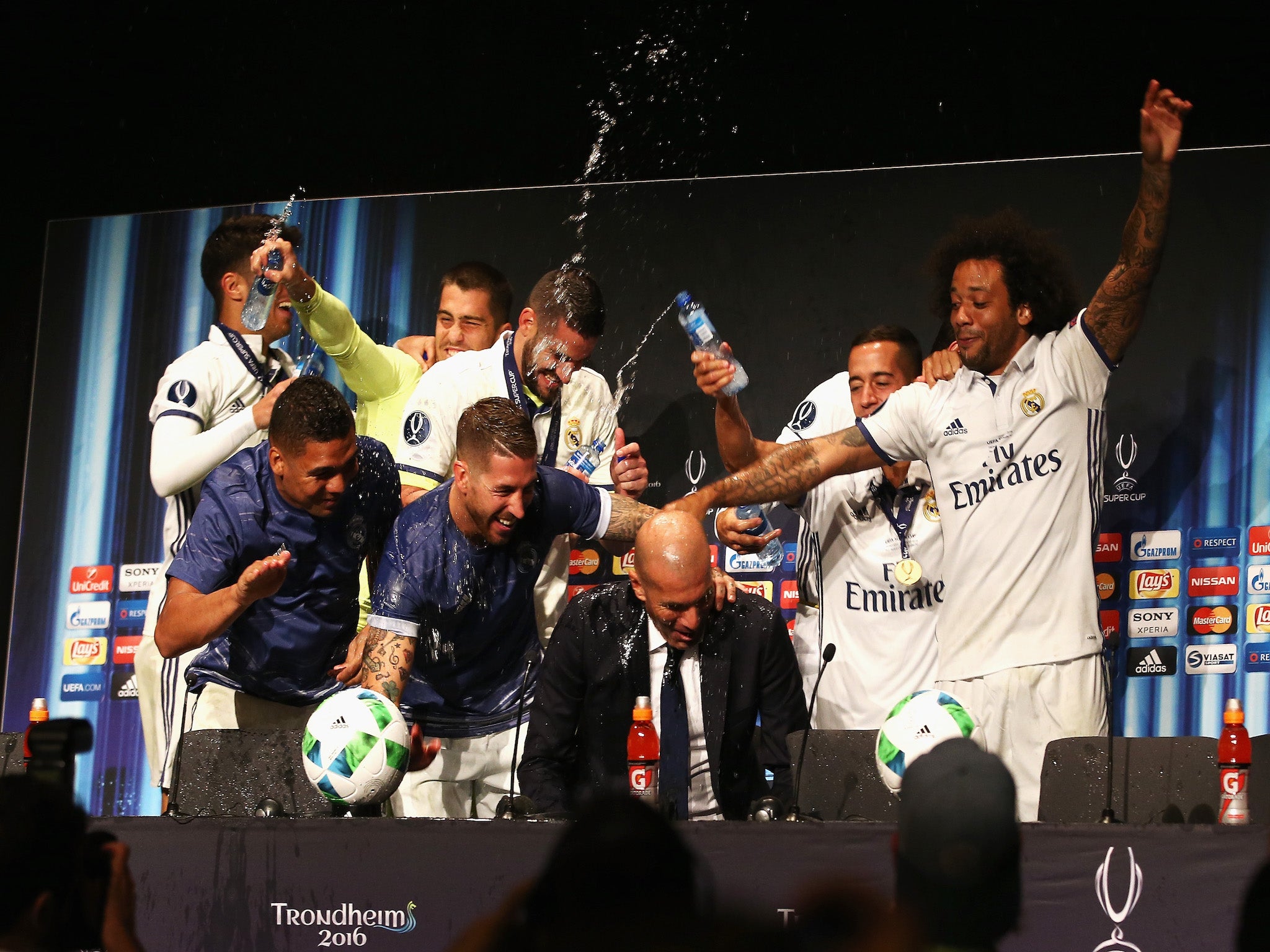 Zinedine Zidane is drenched in water by his Madrid players