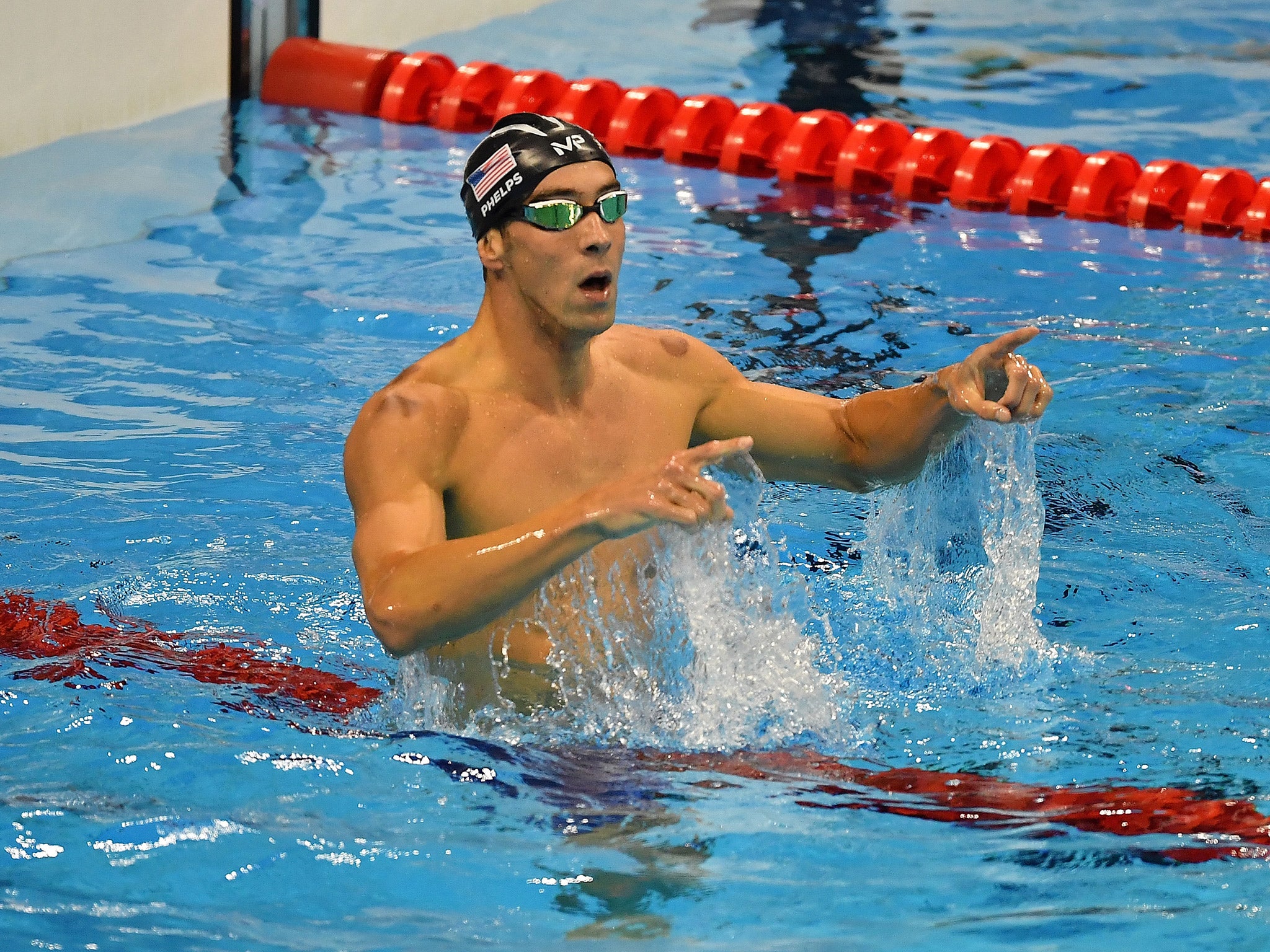 Michael Phelps celebrates his victory in the men's 200m butterfly