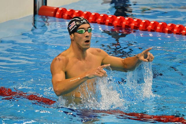 Michael Phelps celebrates his victory in the men's 200m butterfly