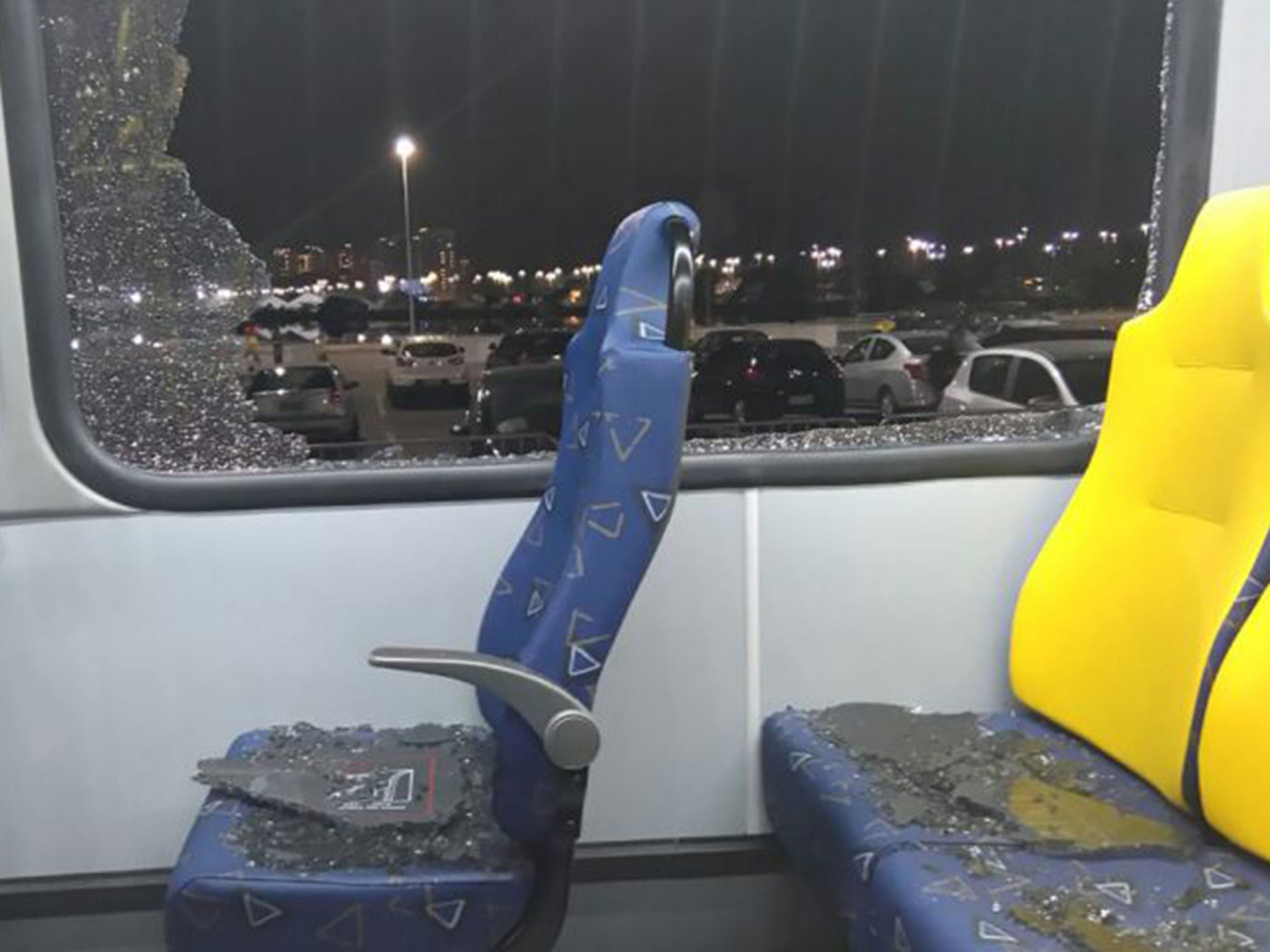 A broken window on an official media bus after it shattered when driving journalists to the main Olympic Park from Deodoro in Rio de Janeiro on 9 August