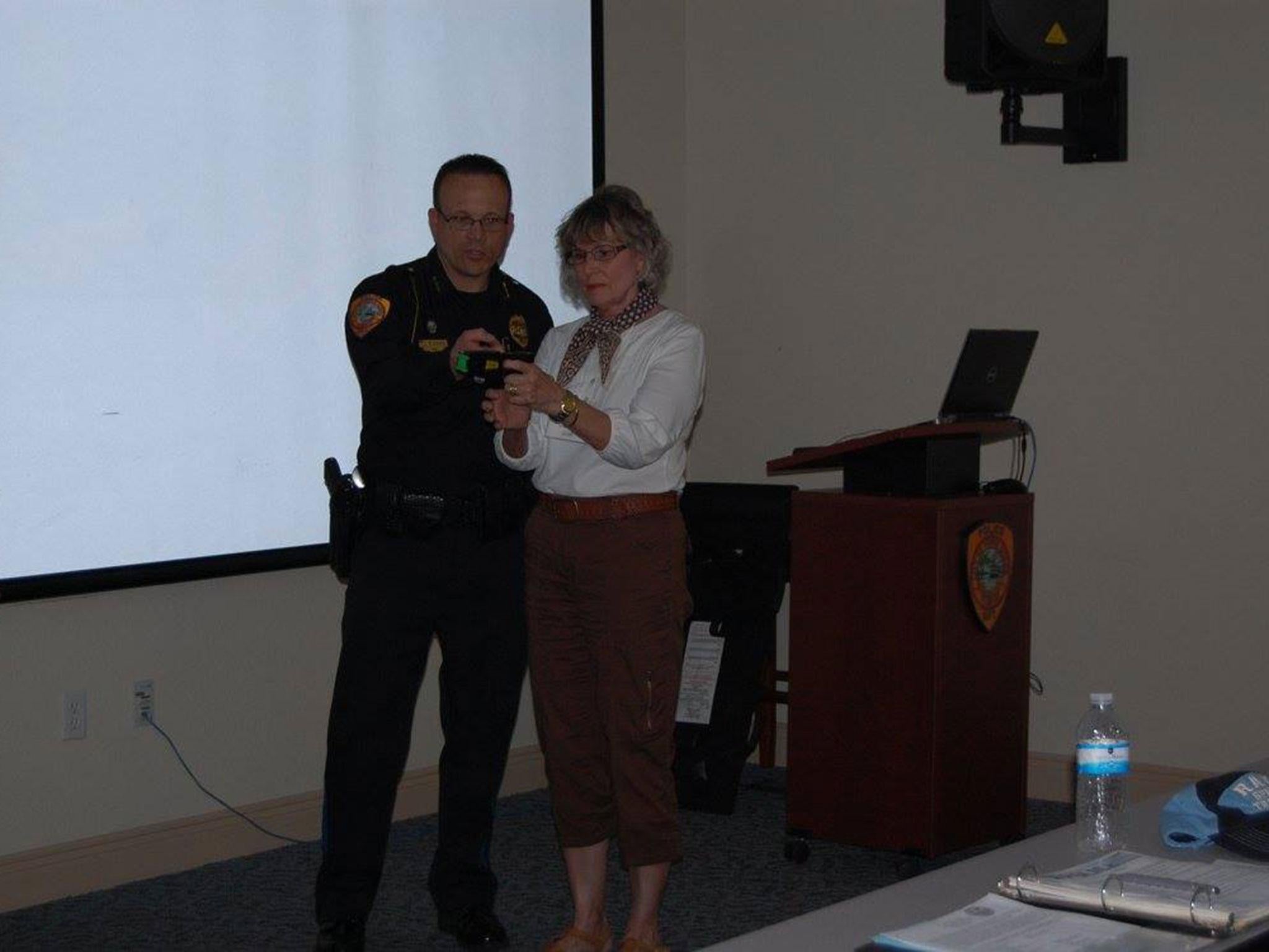 A woman prepares to fire a taser during a Punta Gorda Police Department Citizens Academy class