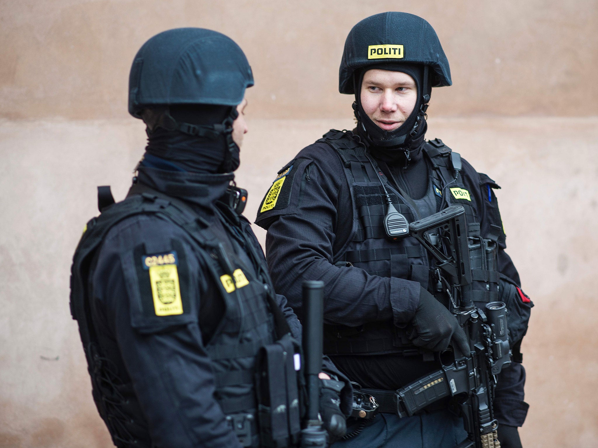 Danish policemen stand guard in front of the city court in Copenhagen, Denmark