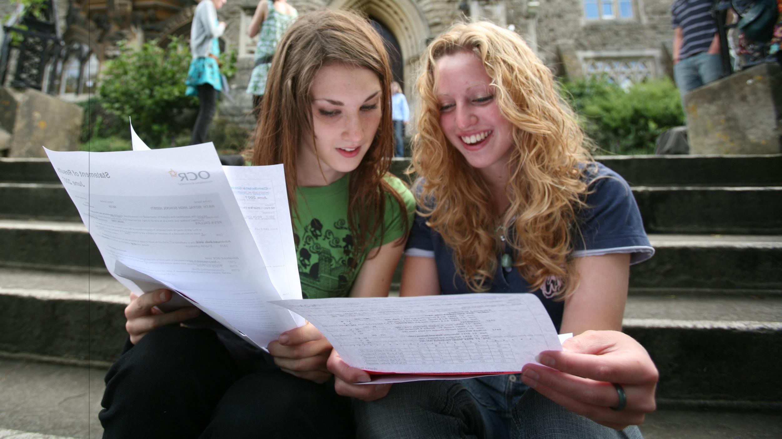 A Level students compare grades on results day. Three per cent more got their first or second choice of university this year than last year