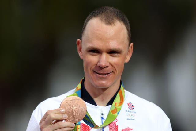 Chris Froome presents his bronze medal after the men's time trial
