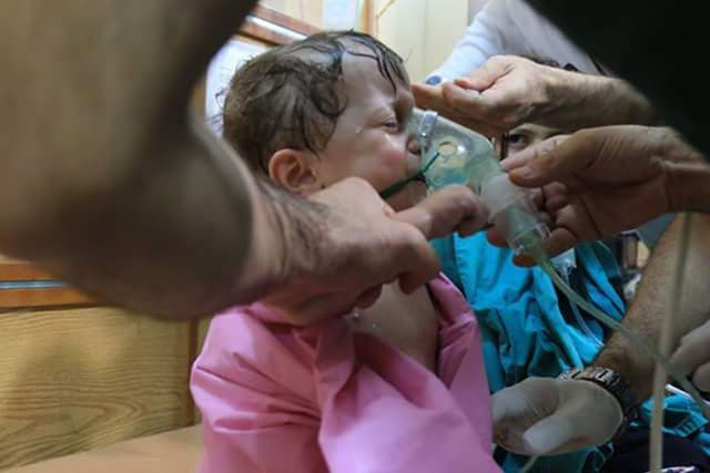A child being treated in hospital after a suspected chlorine gas attack in Aleppo on 10 August