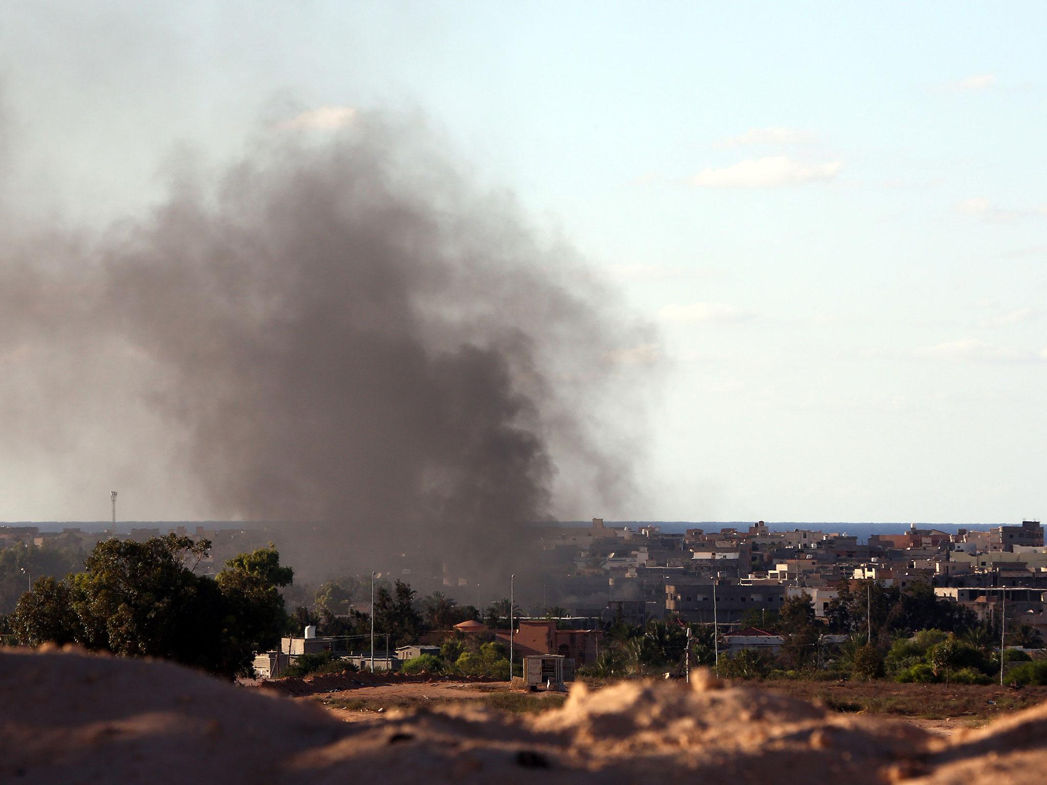 A column of smoke rises above Sirte following air strikes on Isis positions