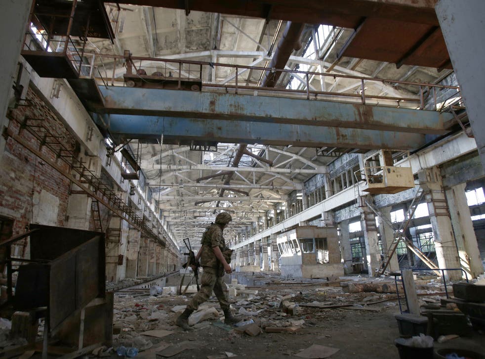 A Ukrainian soldier walks through a shell-damaged factory during a battle with pro-Russian separatists in Avdeyevka last month