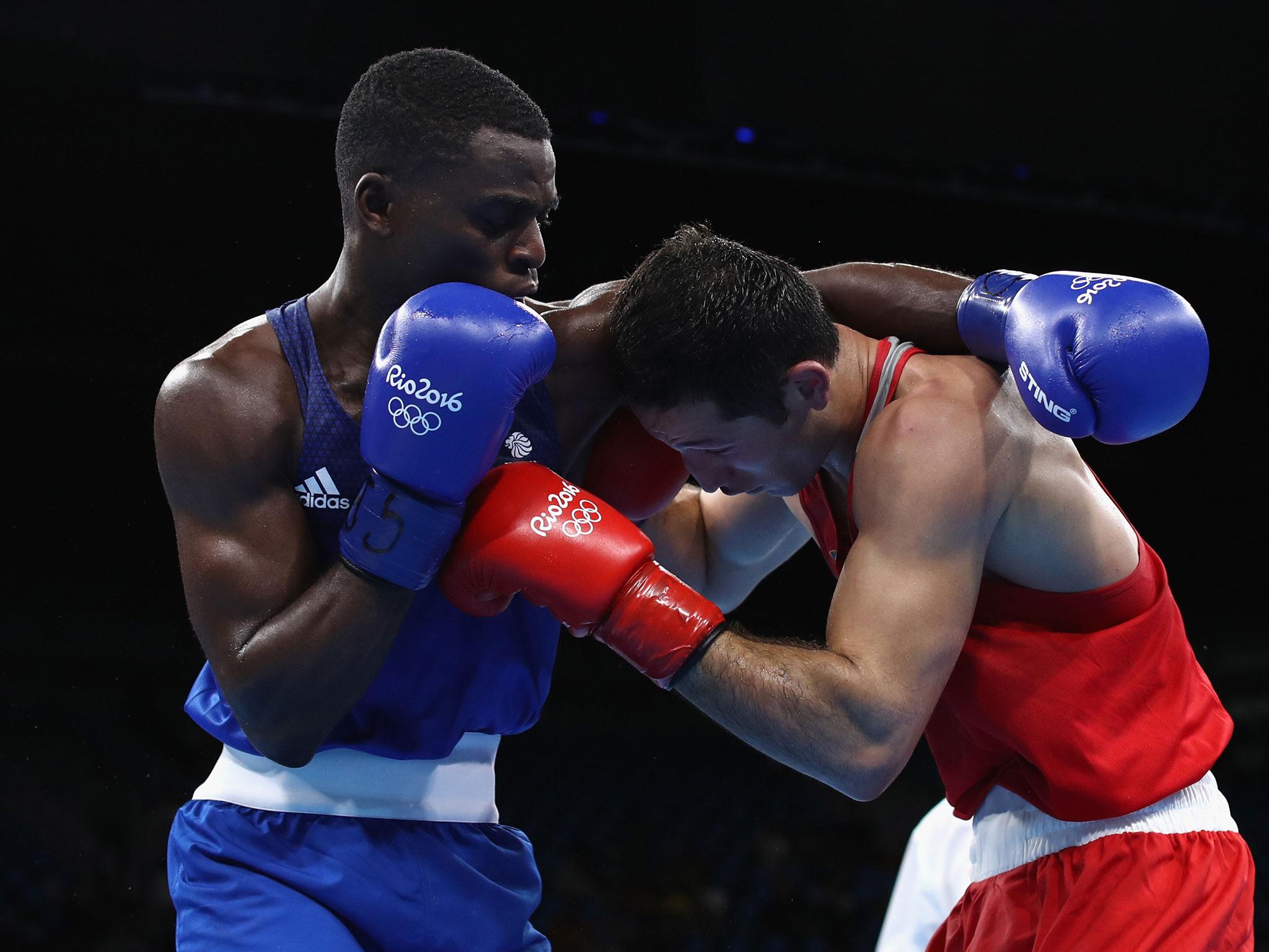 Great Britain's Joshua Buatsi (blue) fights Eishoot Rasulov of Uzbekistan in Mens Light Heavyweight bout